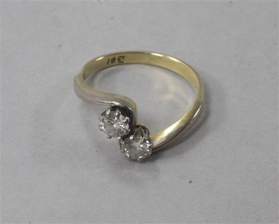 An 18ct gold and two stone diamond crossover ring, size L.